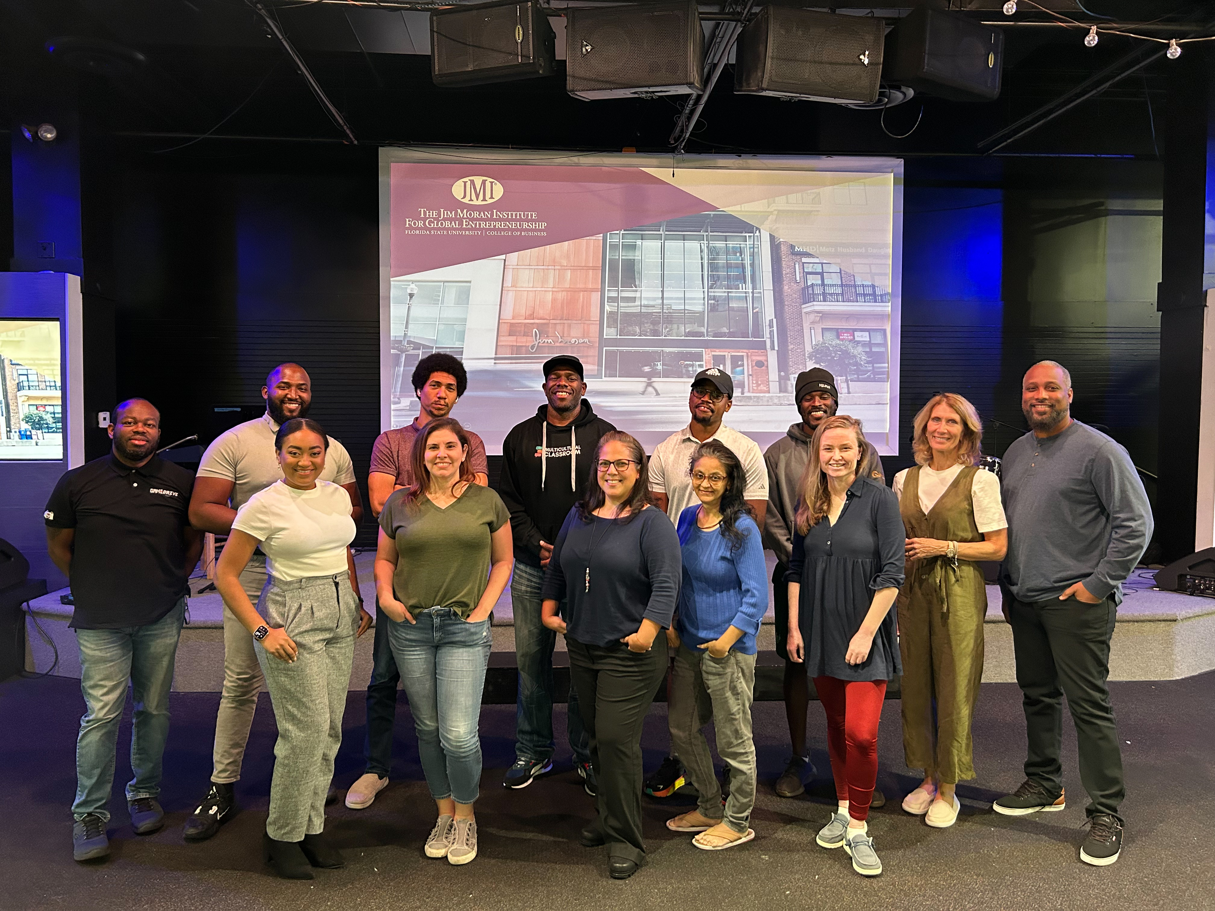 Underrepresented founders sharing progress during a weekly stand‑up.